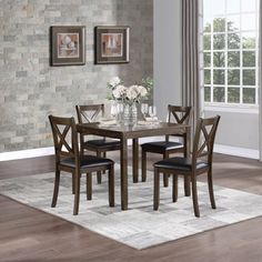 a dining room table with chairs and a rug