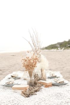 the table is set for two on the beach