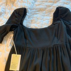 Aritzia Wilfred Moorland Dress Black Brand New With Tags Unworn Only Tried On, Never Worn Out Fit: Slim Streamlined To Fit Close To The Body Length: Mini Intended To Hit Between Upper And Mid Thigh Features Invisible Side Zipper Smocked Back Panel Elastic Sleeve Cuffs Scalloped Edge At Cuffs And Hem Materials & Care Content: 52% Viscose, 48% Lenzing Ecovero Viscose; Lining: 52% Viscose, 48% Lenzing Ecovero Viscose; Elastic: 69% Polyester, 31% Rubber Suede Mini Dress, Striped Shift Dress, Chiffon Mini Dress, Spaghetti Strap Mini Dress, Free Dresses, Tan Dresses, Tank Top Dress, Aritzia Wilfred, Shift Dress Black