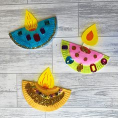 three paper plates with different designs on them sitting on a white wooden floor next to each other