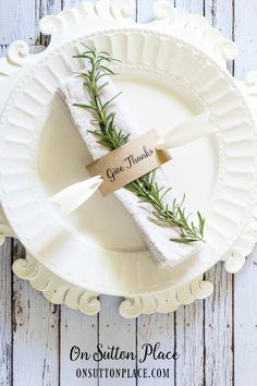 a white plate topped with two napkins covered in herbs