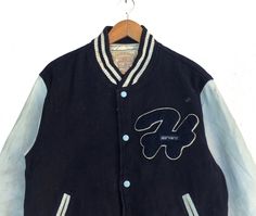 PLEASE ASK ANY QUESTION BEFORE BUYING THIS IS USED CLOTHING PLEASE DONT EXPECTED IT TO BE LIKE NEW OR IN PRISTINE CONDITION Vintage 90s Harvard University Button Down Varsity Jacket Blue Colour Wool Sweater Size Large Fit To Medium tag Harvard material Wool 100% saiz on tag L (Large) fit To Medium Mesasures About ( Approximately) -Armpit to Ampit : 22.5 inch -Length (back collar down) : 25 inch Condition : used good condition 7.5/10 **No Tears And No Stains** **Have a one Hole see a picture deta Blue Buttoned Outerwear For Streetwear, Winter Streetwear Button-up Varsity Jacket, Blue Varsity Jacket With Button Closure For Streetwear, Blue Varsity Jacket For Streetwear, Vintage Varsity Jacket With Button Closure For Winter, Vintage Winter Varsity Jacket With Button Closure, 90s Style Varsity Jacket For Winter Streetwear, 90s Style Winter Varsity Jacket For Streetwear, Vintage Varsity Jacket With Button Closure For Streetwear