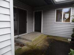 the front door of a house with steps leading up to it