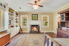 a living room filled with furniture and a fire place