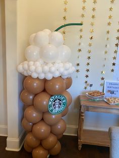 there is a starbucks balloon tower in the room