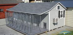 a dog kennel in front of two garages