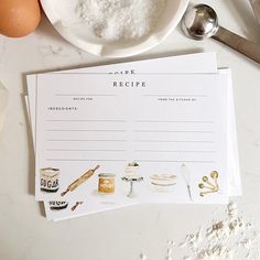 a recipe card sitting on top of a table next to eggs and utensils