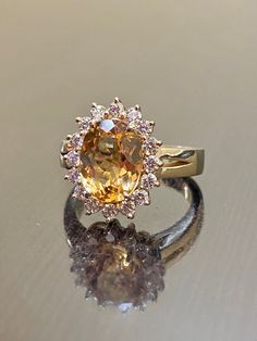 DeKara Designs Classic Metal- 14K Yellow Gold, .583. Stones- 1 Oval Imperial Topaz 3.50 Carats, 16 Round Diamonds G Color VS1 Clarity 0.55 Carats. Size- Choose Your Size, from 4-12. Please allow three to five working days for me to ship out your ring. I will start on making your ring as soon as transaction has been processed. Classic 14K yellow gold Art Deco influenced halo Imperial Topaz diamond engagement ring. The center stone is a whopping prong set 3.15 fiery oval shaped Peach colored beaut Vintage Topaz Engagement Rings, Yellow Topaz Ring Designs, Yellow Topaz Engagement Ring, Imperial Topaz Engagement Ring, Topaz Engagement Ring Yellow, Gold Topaz Engagement Ring, Cartier Wedding Rings, Imperial Topaz Ring, Yellow Topaz Ring