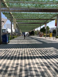 an empty walkway with people walking down it