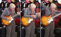 a man playing an electric guitar in a store