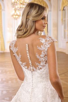 a woman in a white wedding dress looking back