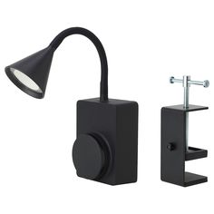 a black wall light next to a black lamp