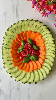 an arrangement of fruits and vegetables arranged in the shape of a face on a marble surface