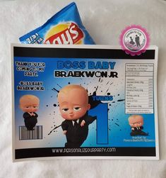 an envelope with a baby doll on it and a candy bar wrapper next to it