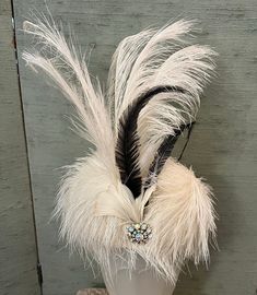 1920 vintage white aigrette feathered hat with white and black plumes standing 7 inches high with a gorgeous rhinestone pin nestled in the front of the dome base. This is a spectacular hat, beautifully preserved and ready for a party or Ascot or both! Size 22", dome 5", plume 7". White Feathered Evening Headpieces, White Feathered Headpieces For Evening, White Feather Headpieces For Evening, White Ostrich Feather Headpiece With Feather Trim, Feathered Hat, Textiles Projects, Feather Hat, Black Feathers, Project Ideas