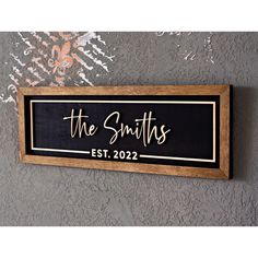 a wooden sign that says the smiths est 202 on it, hanging on a wall