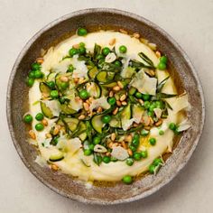 a bowl filled with vegetables and sauce on top of a table