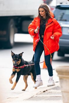 a woman walking her dog on a leash