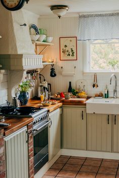 a kitchen filled with lots of counter top space and wooden cabinets next to a window