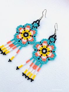 These beautiful Mexican earrings are so colorful and perfect for all-day wear. They are definitely the perfect accessory to style up your look and add personality to your outfit. These lovely handmade earrings are made with sterling silver hooks and colorful beads. The length of the beaded Earrings is approximate of 3 inches (8 cm) Each pair of earrings that we sell is authentic and one-of-a-kind! Thank you so much for visiting. If you have any questions, please do not hesitate to contact us. Multicolor Bead Cap Drop Earrings, Multicolor Drop Earrings With Bead Caps, Multicolor Flower-shaped Earrings With Dangling Beads, Unique Multicolor Beaded Flower Earrings, Bohemian Multicolor Earrings With Bead Caps, Colorful Beads Adjustable Drop Earrings, Colorful Beaded Adjustable Drop Earrings, Bohemian Flower-shaped Earrings With Colorful Beads, Bohemian Flower-shaped Beaded Earrings