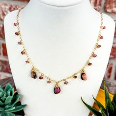 Elevate your boho style with this beautiful watermelon Tourmaline necklace. The natural tourmaline slices and beads dance along a 14k gold-filled chain, bringing a perfect mix of earthy vibes and a touch of luxe. You can view our full line of handmade gemstone necklaces here: https://www.etsy.com/shop/WanderlustDesignTX?section_id=40696534 Details: *Materials: Genuine watermelon tourmaline slices and beads, 14k gold-filled chain, and lobster clasp. *Length: Adjustable from 17.5 to 19 inches, so Handmade Tourmaline Artisan Necklace, Handmade Artisan Tourmaline Necklace, Bohemian Tourmaline Jewelry With Natural Stones, Adjustable Tourmaline Gemstone Necklace, Pink Tourmaline Bohemian Jewelry, Handmade Bohemian Tourmaline Necklace, Handmade Pink Tourmaline Necklaces, Handmade Pink Tourmaline Necklace, Handmade Tourmaline Bohemian Jewelry