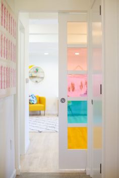 an open door leading to a brightly colored room