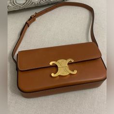 Celine Triomphe Tan Brown Natural Calfskin Shoulder Bag 8 X 5 X 2 In (20.5 X 11.5 X 4 Cm) Natural Calfskin Lambskin Lining Gold Finishing Triomphe Metallic Closure One Main Compartment One Inner Flat Pocket Adjustable Strap With A Minimum Drop 8 In (21 Cm) And Maximum Drop 10 In (25 Cm) Pre Owned In Excellent Condition. There Are Some Minor Scratches As Shown. There Is One Minor Discoloration Inside The Pocket As Shown In Picture Number 16 There Is No Dust Bag. Celine Triomphe, Number 16, Celine Bags, Tan Brown, Calf Skin, Adjustable Straps, Dust Bag, Bag Lady, Shoulder Bag