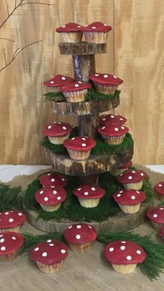 cupcakes are arranged in the shape of a tree with red and white mushrooms on them