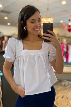 Poplin baby doll puff short sleeve square neck top. Slightly cropped. Model is wearing a size small. Stocked at Arlington Village and Uptown. Short Sleeve Puff Top With Smocked Bodice For Daywear, Daywear Puff Sleeve Top With Smocked Bodice, Puff Sleeve Top With Smocked Bodice For Daywear, White Square Neck Blouse, White Feminine Puff Sleeve Top With Square Neck, Cute Puff Sleeve Top For Day Out, Cute White Square Neck Top, Casual Square Neck Puff Sleeve Top For Daywear, Casual White Puff Sleeve Top With Square Neck