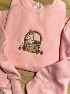 Introducing our Strawberry Basket Bunny Embroidered Sweatshirt 2D Crewneck Sweatshirt, a delightful and charming addition to your wardrobe. Designed for both men and women, this sweatshirt is a perfect blend of comfort, style, and versatility. At first glance, the detailed embroidery of a cute bunny nestled in a basket of fresh strawberries catches your eye. The intricate stitching brings the design to life, adding a touch of playfulness to your outfit. Made with precision and care, this embroid Pink Sweatshirt Embroidered, Cheap Cute Embroidered Sweater, Cheap Pink Embroidered Sweater, Strawberry Embroidered Sweatshirt, Spring Floral Embroidery Sweatshirt, Cute Embroidery Sweatshirts & Hoodies, Casual Embroidered Hoodie Sweatshirt, Cute Custom Embroidered Sweatshirt For Streetwear, Pink Long Sleeve Hoodie With Embroidered Logo