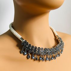 Women's Indian Dark Grey Necklace - Handcrafted Traditional Kundan Ethnic Jewellery Add a touch of tradition and sophistication to your collection with this Women's Indian Dark Grey Necklace. Handcrafted with meticulous care, this necklace features a rich dark grey tone, enhanced by hand-tampered Kundan work, reflecting the elegance and beauty of Indian ethnic craftsmanship. The intricate detailing of the Kundan stones combined with the bold statement design makes this necklace a stunning choice White Bohemian Necklaces With Latkans, Bohemian White Necklaces With Latkans, White Bohemian Jewelry With Latkans, Bohemian White Jewelry With Latkans, Bohemian White Necklaces With Silver Beads, Grey Necklace, Jewellery Traditional, Kundan Work, Gray Necklace