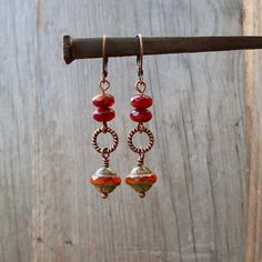 Perfect for fall! The beads on these earrings are all Czech glass beads. They are a mix of oranges. They are available with antique brass or copper findings. They are also available with titanium ear wire. The bottom bead is 10mm, Saturn shaped bead with a Picasso finish. The top beads are a terra cotta and clear dark red (almost Burgundy) bead they are 4x7mm. This listing is for the earrings shown in the first few photos. NOTE: If you want titanium, but prefer copper on the rest of the earrings Bohemian Glass Drop Earrings, Nickel-free Glass Bohemian Earrings, Nickel Free Czech Glass Dangle Earrings, Adjustable Czech Glass Earrings With Ear Wire, Wire Wrapped Glass Dangle Earrings, Glass Wire Wrapped Dangle Earrings, Nickel-free Czech Glass Drop Earrings, Wire Wrapped Glass Bead Earrings, Czech Glass Dangling Beads Drop Earrings