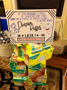 a diaper raffle sign is stacked on top of boxes