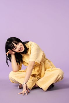 a woman kneeling on the ground posing for a photo