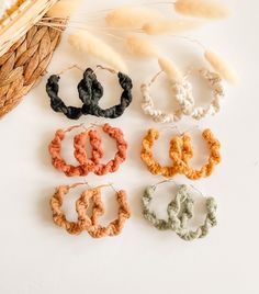 four pairs of braided hair clips sitting next to each other