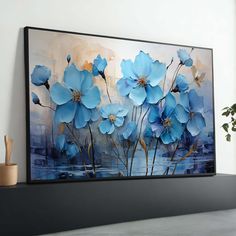 a painting on the wall with blue flowers