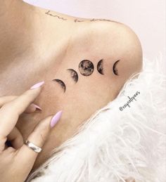 a woman with three phases of the moon tattoo on her left shoulder