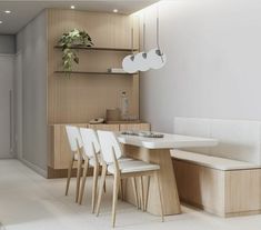 a dining room table with white chairs and a bench in front of the counter top