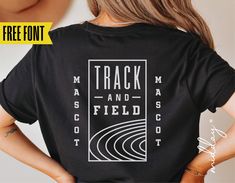 a woman wearing a black t - shirt that says track and field on the back