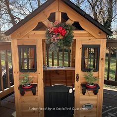 a small wooden house with potted plants on it