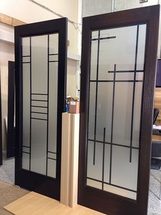 two glass doors sitting next to each other on top of a wooden table in an office