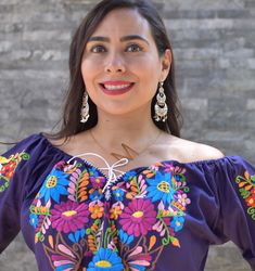 This lovely dress was handmade in Mexico. The beautiful colorful flowers were embroidered by hand, so each one is unique. You will love wearing this comfortable cotton dress with short sleeves. It is perfect for a hot summer day. This dress comes just above or below the knee, depending on how tall you are. It has a square neckline and cute little puffy sleeves. Inch measure Medium 19 * 35 Large 23 * 37 XL 26 * 37 XXL 27 * 38 About Our Items: Each one of our items is handmade/hand woven by Indige Folk Style Dresses With Floral Embroidery For Festivals, Festival Multicolor Floral Embroidery Dress, Multicolor Floral Embroidered Festival Dress, Folk Style Multicolor Embroidered Dress With Floral Print, Multicolor Floral Embroidery Dress For Festival, Multicolor Floral Embroidery Festival Dress, Traditional Purple Floral Print Dress, Multicolor Embroidered Floral Dress For Festivals, Multicolor Floral Print Embroidered Dress For Festival