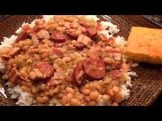 a plate with rice, beans and cornbreads on it next to a piece of bread