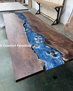 a table made out of wood with blue water running down the center and on top