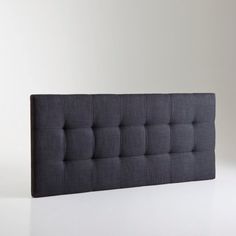 an upholstered headboard is shown against a white background with no people around it