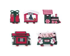 four small christmas train ornaments with candy in them