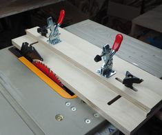 a table sawing machine with tools attached to the handle and blades on it