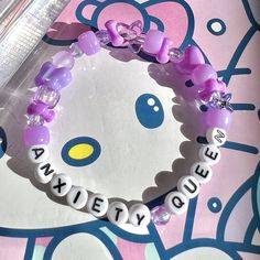 a hello kitty bracelet with name charms on it