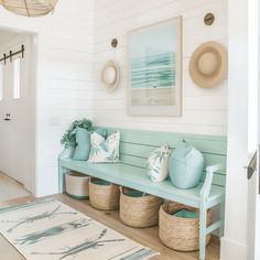 a blue bench sitting in the middle of a living room next to a white door