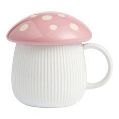 a pink and white cup with a mushroom on the top is sitting in front of a white background